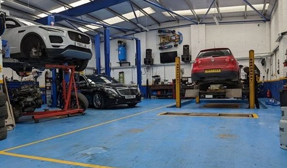 Cars on the lifts in the AST workshop